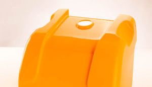 Orange plastic part that was deepdrawn